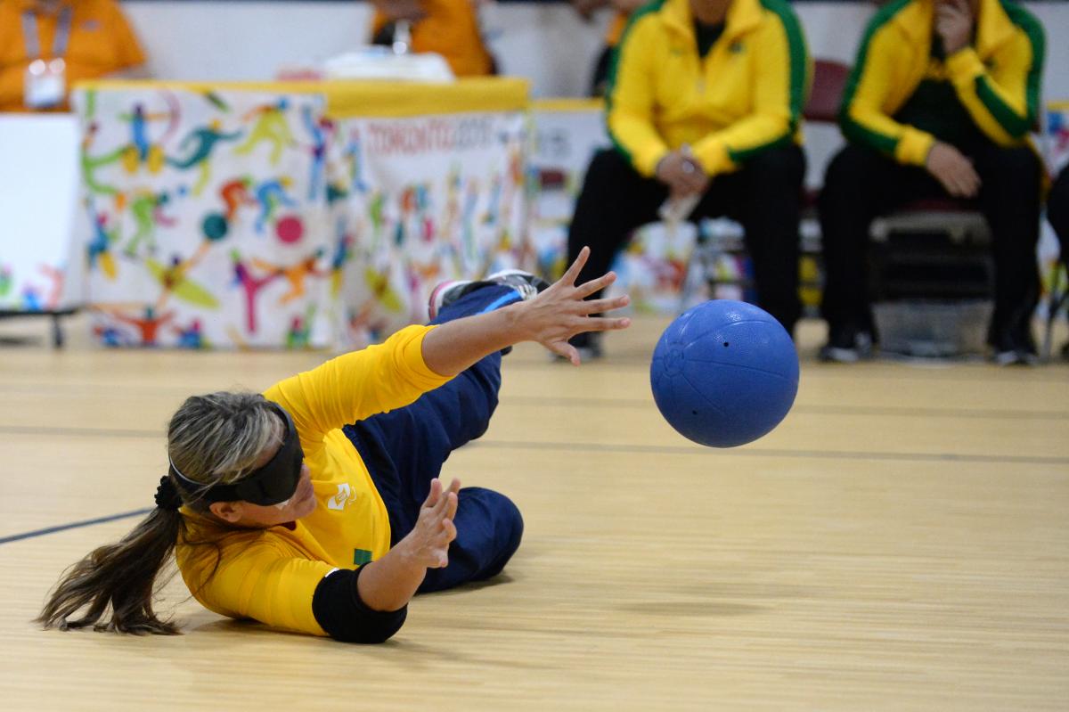 Blindfolded woman catching the ball during a goalball match