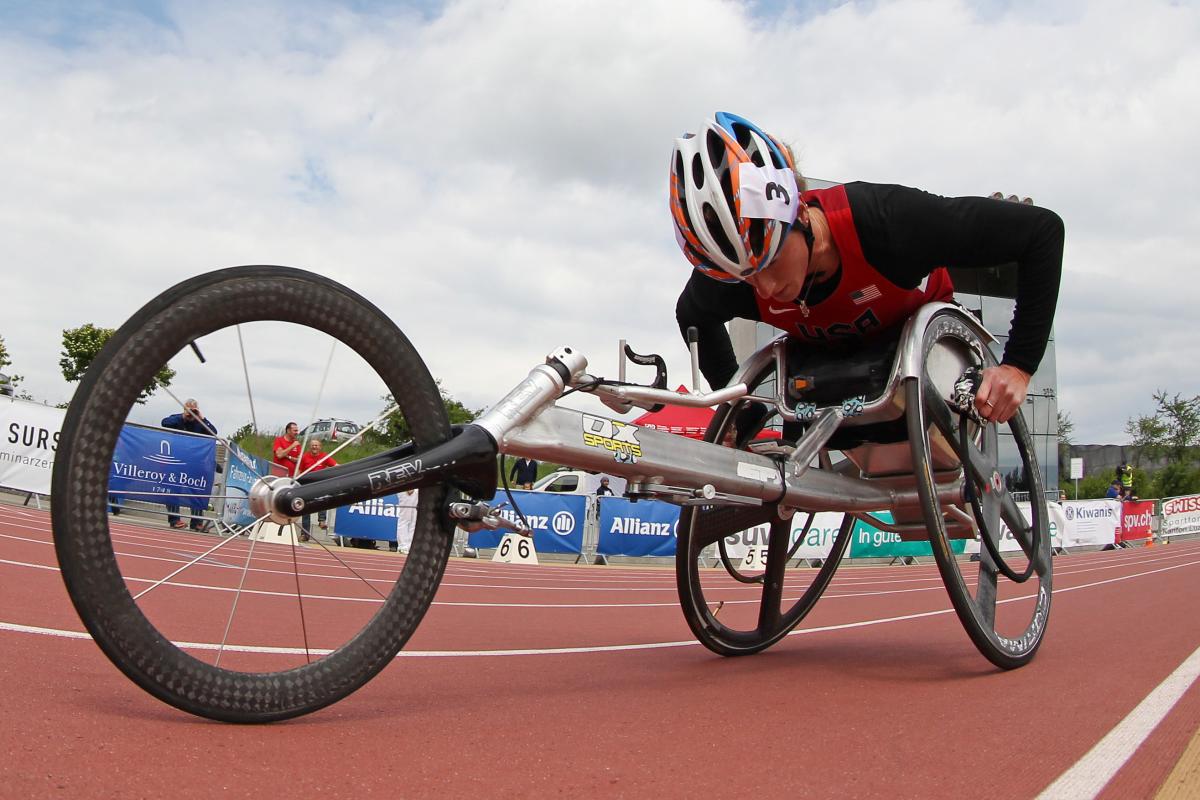 Woman in a racing wheelchair competing