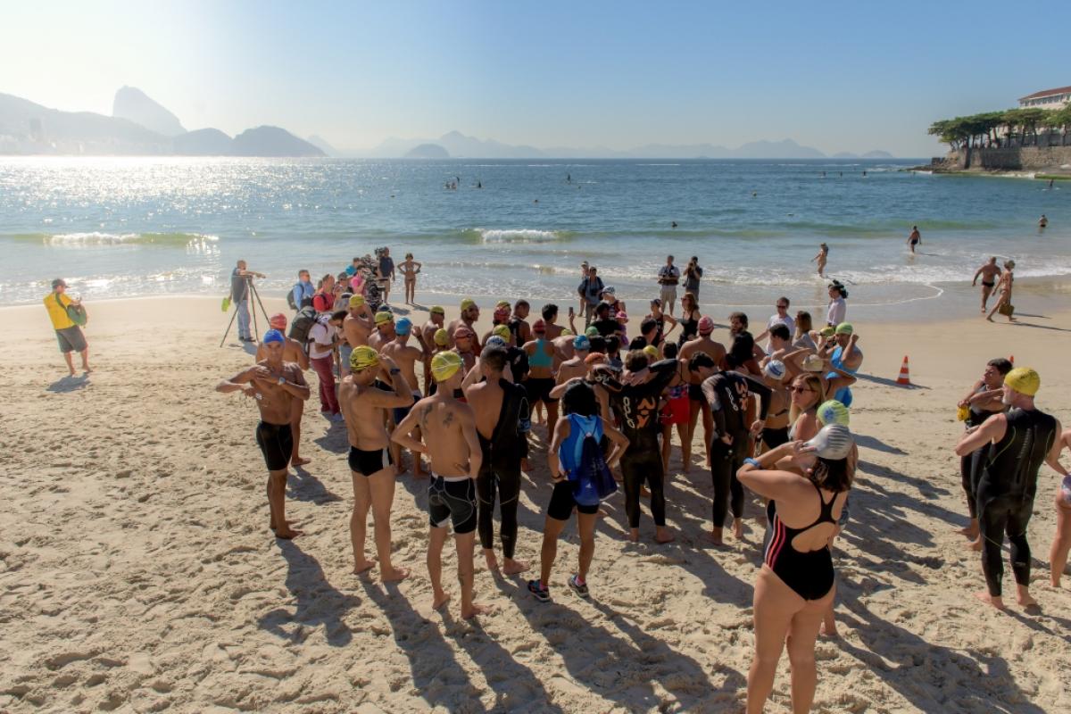 Group of athletes on the beach, duscussing