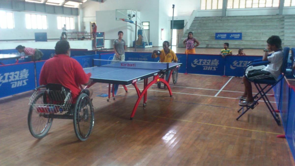 Para-table tennis competition in Kiribati Two men in wheelchairs playing table tennis