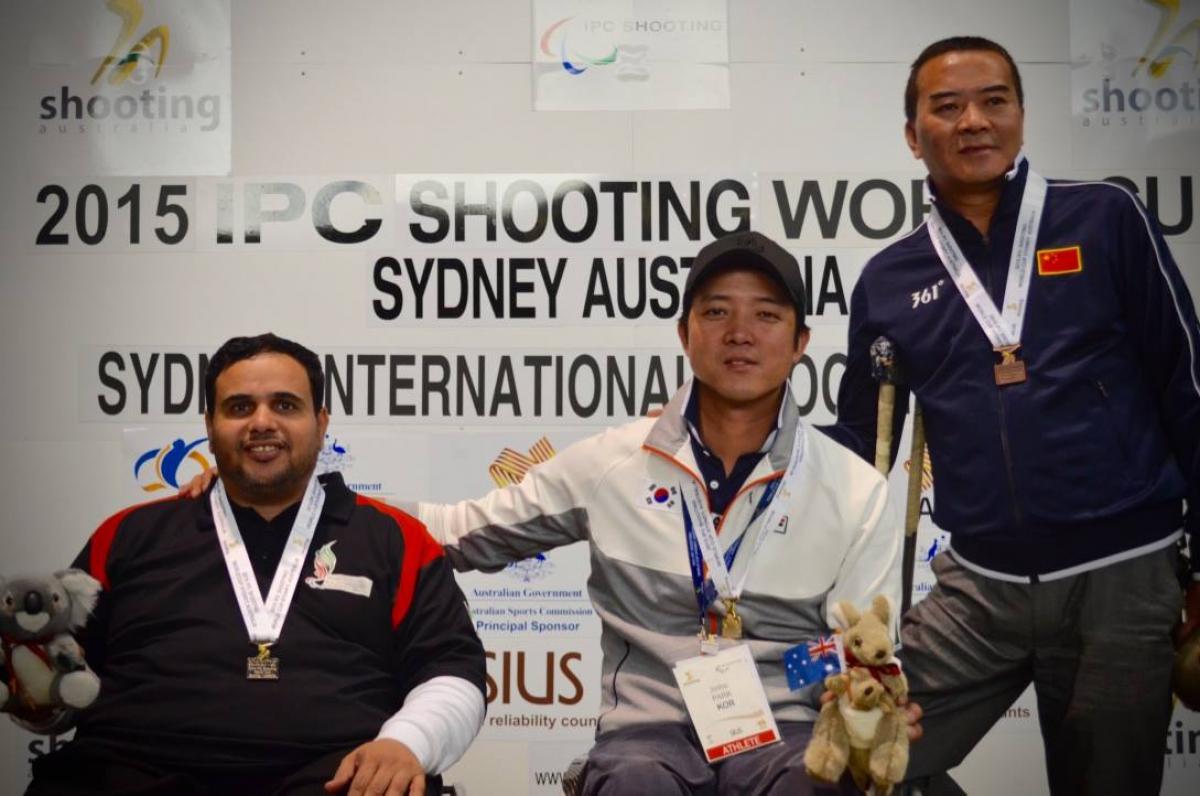 Jinho Park - South Korea - IPC Shooting World Cup Sydney Three men on a podium with medals