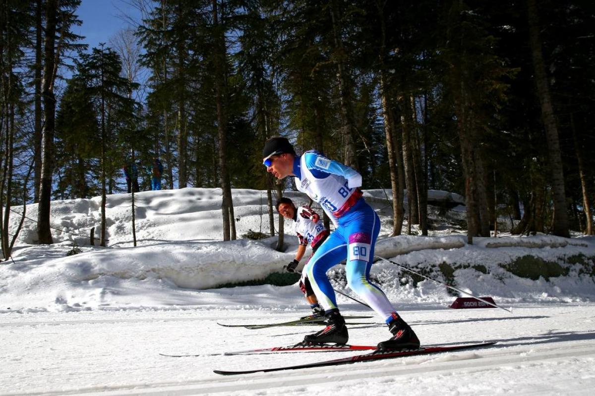 Ilkka Tuomisto of Finland and Dexin Zhou of China compete in the Men's Cross Country 10km Free Standing at the Sochi 2014 Paralympic Winter Games.