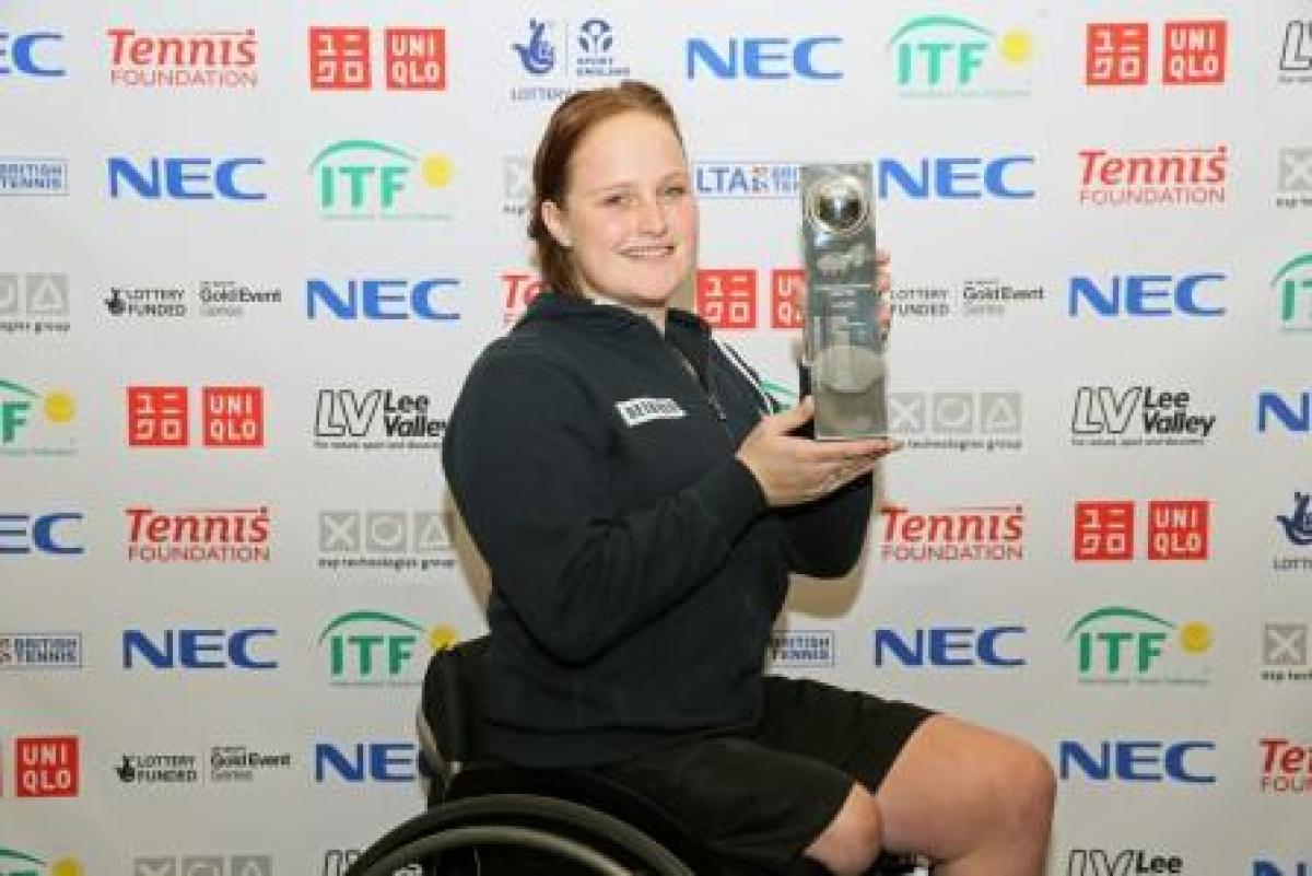 Woman with a cup, sitting in a wheelchair