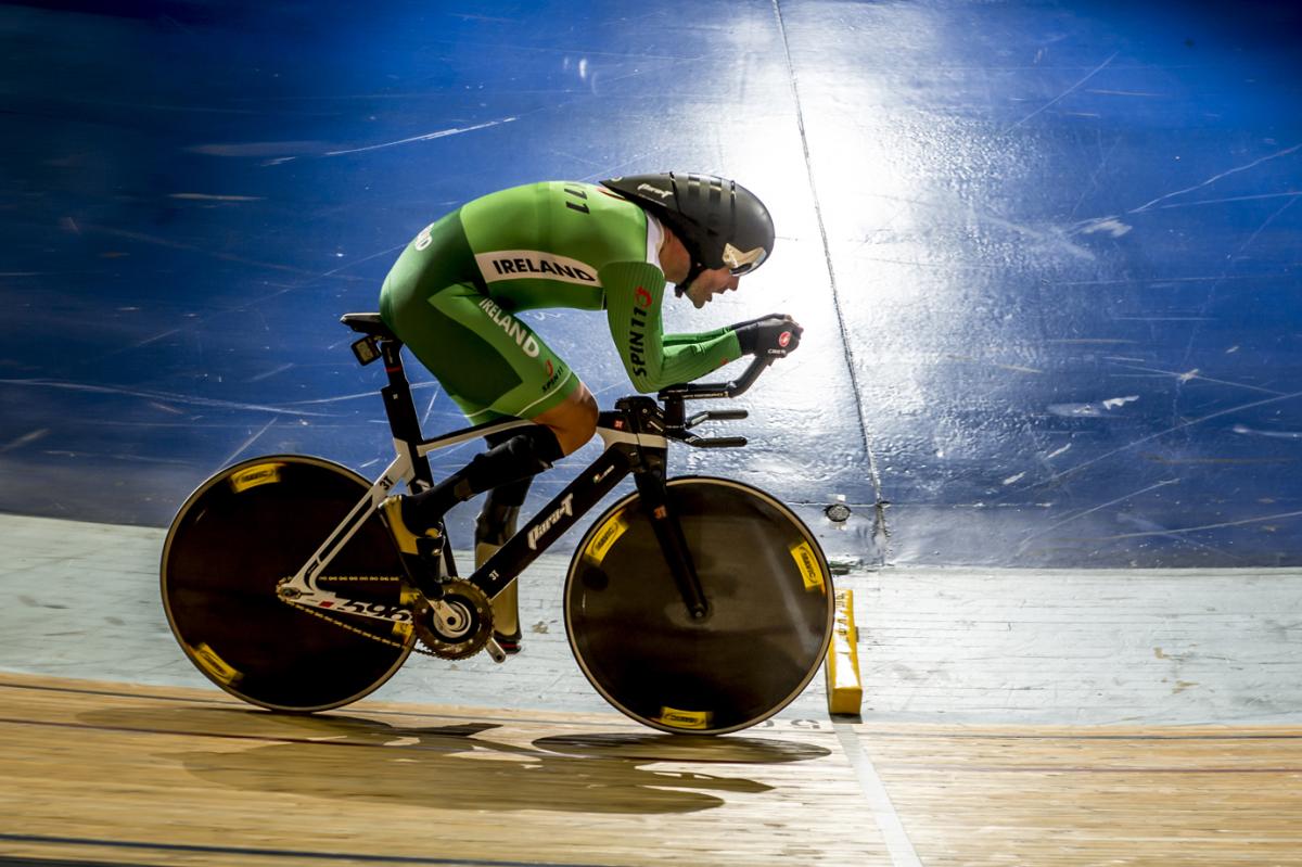 Man on a bike, cycling on a track