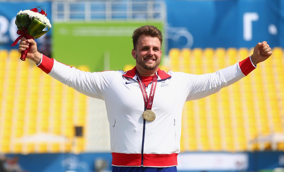 Great Britain's Aled Davies poses with his gold medal at the medal ceremony for the men's shot put F42 final at the 2015 IPC Athletics World Championships in Doha, Qatar. 