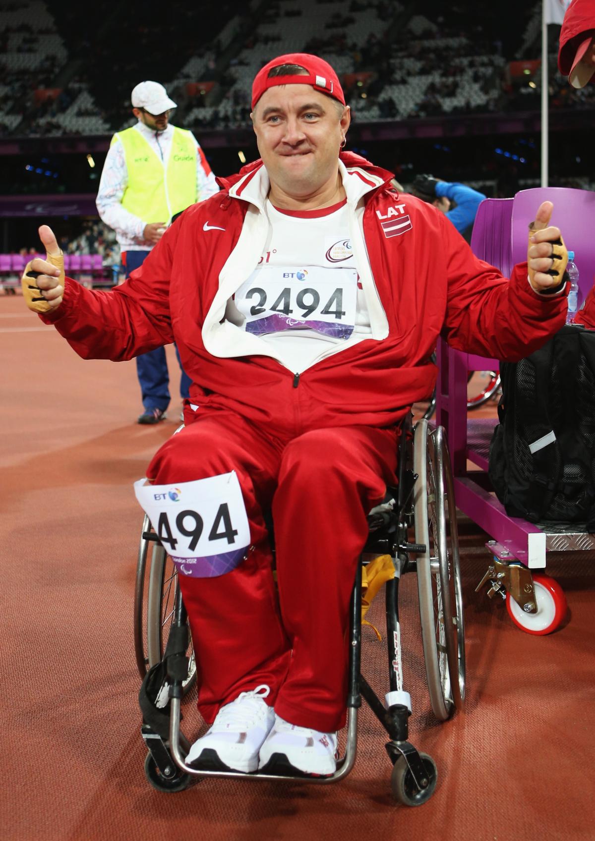 Man in wheelchair showing thumbs up