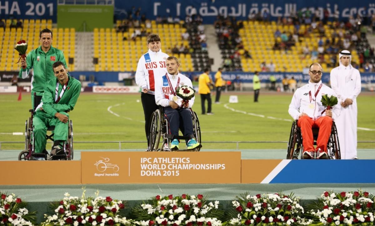 Podium with three men in training suits