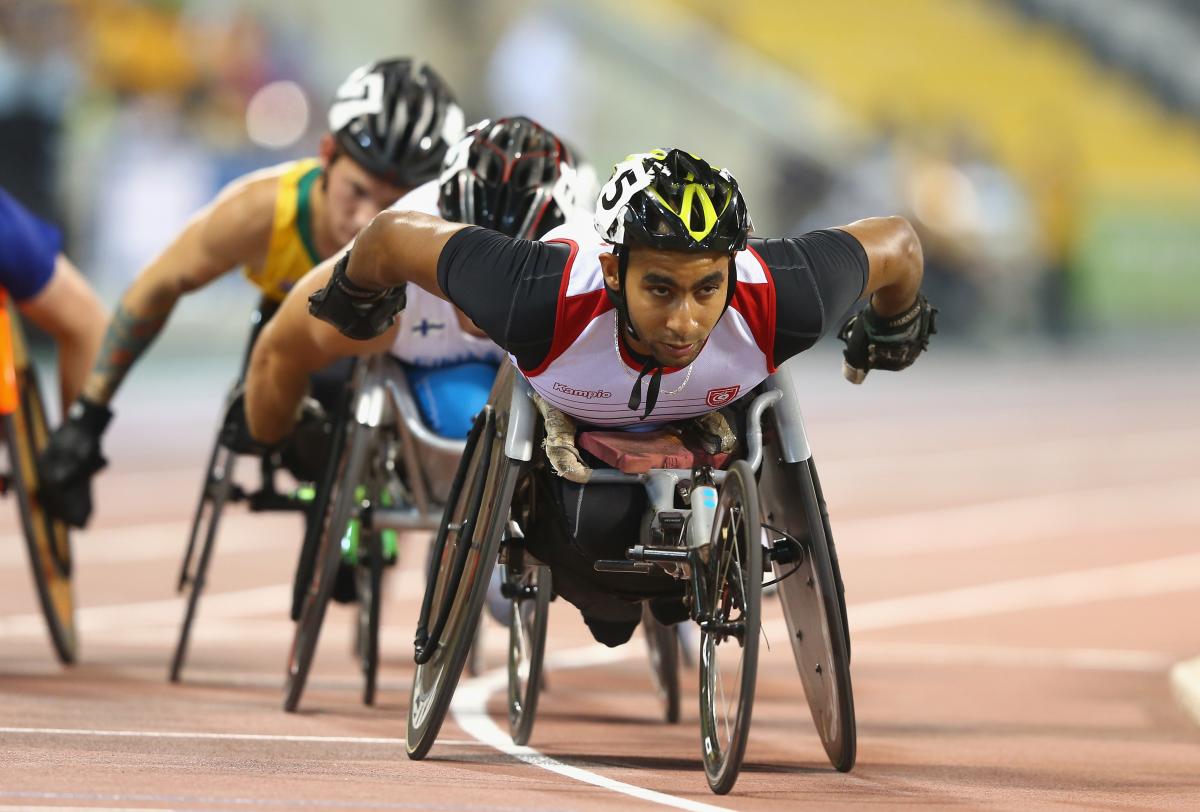 Man leading a pack in a wheelchair race