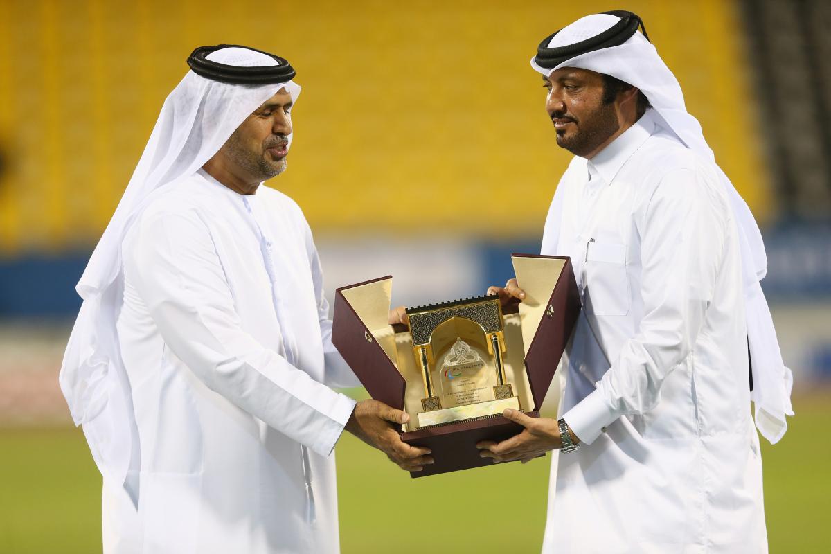 Mr Ameer Al Mulla (R) presents a gift to Mr Mohammed Alhameli at the closing ceremony of the IPC Athletics World Championships at Suhaim Bin Hamad Stadium in DOha, Qatar.