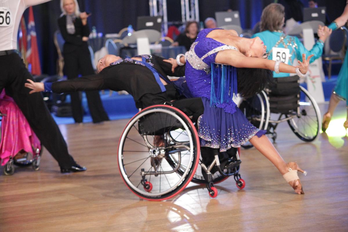Wheelchair dance sport Man in wheelchair and woman performe.