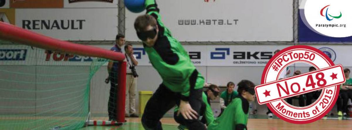 Goalball scene with one player throwing the ball