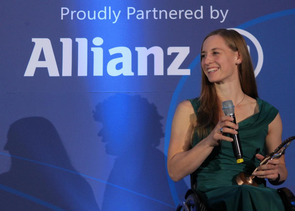 Anna Schaffelhuber with her awards trophy, smiling