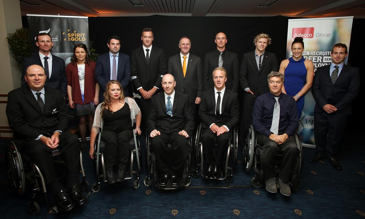 Group picture of people dressed smart, standing and in wheelchairs
