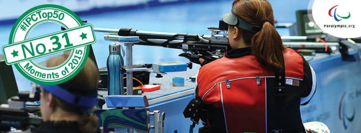 Women from the back, targeting with a rifle