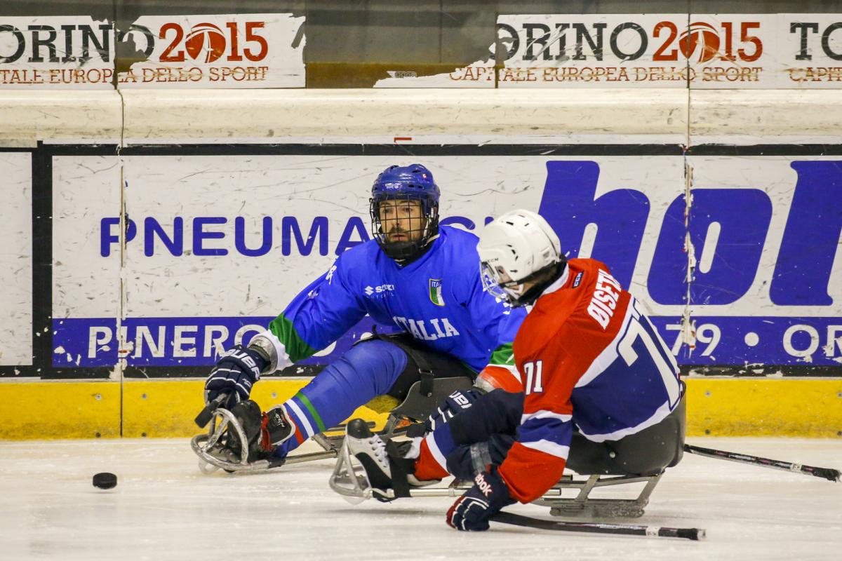 Two ice sledge hockey players in action