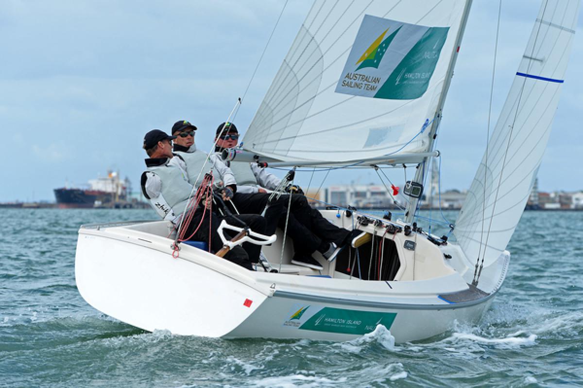 Three men in a boat sailing