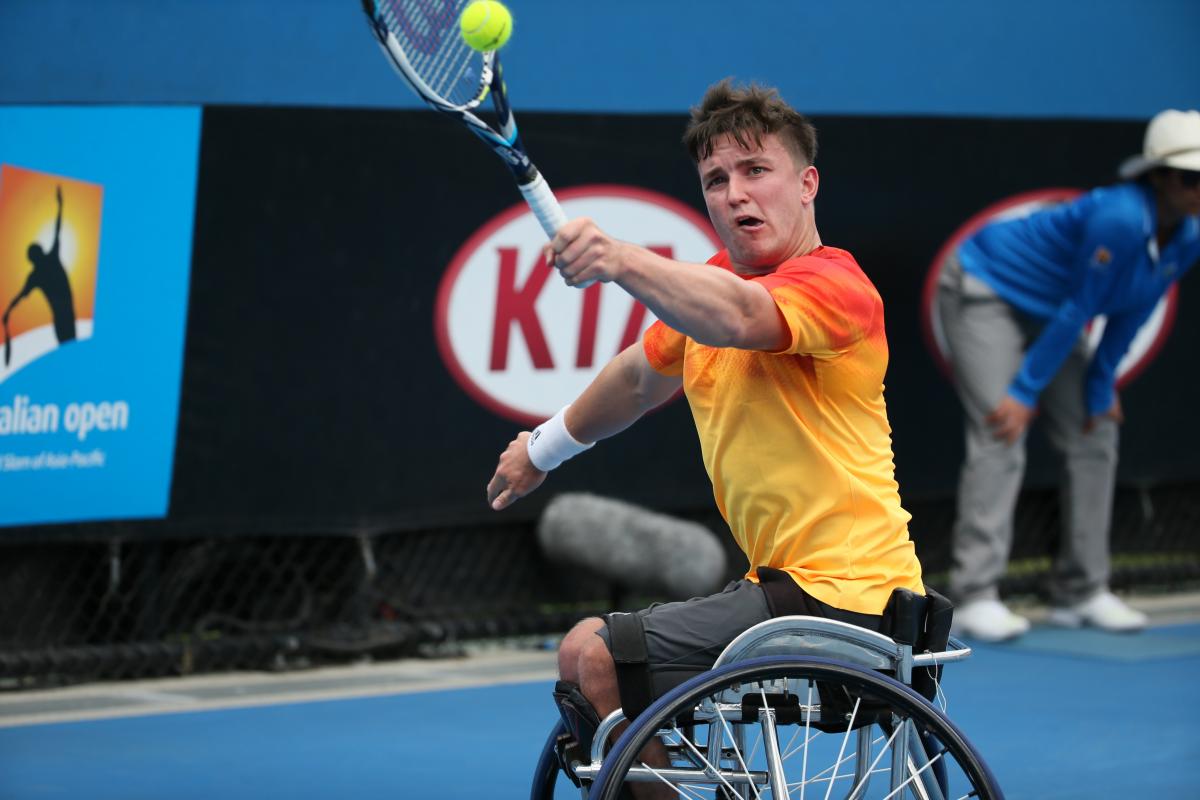 Gordon Reid - Great Britain - wheelchair tennis - Australian Open Man in wheelchair, hitting a ball with a tennis racket
