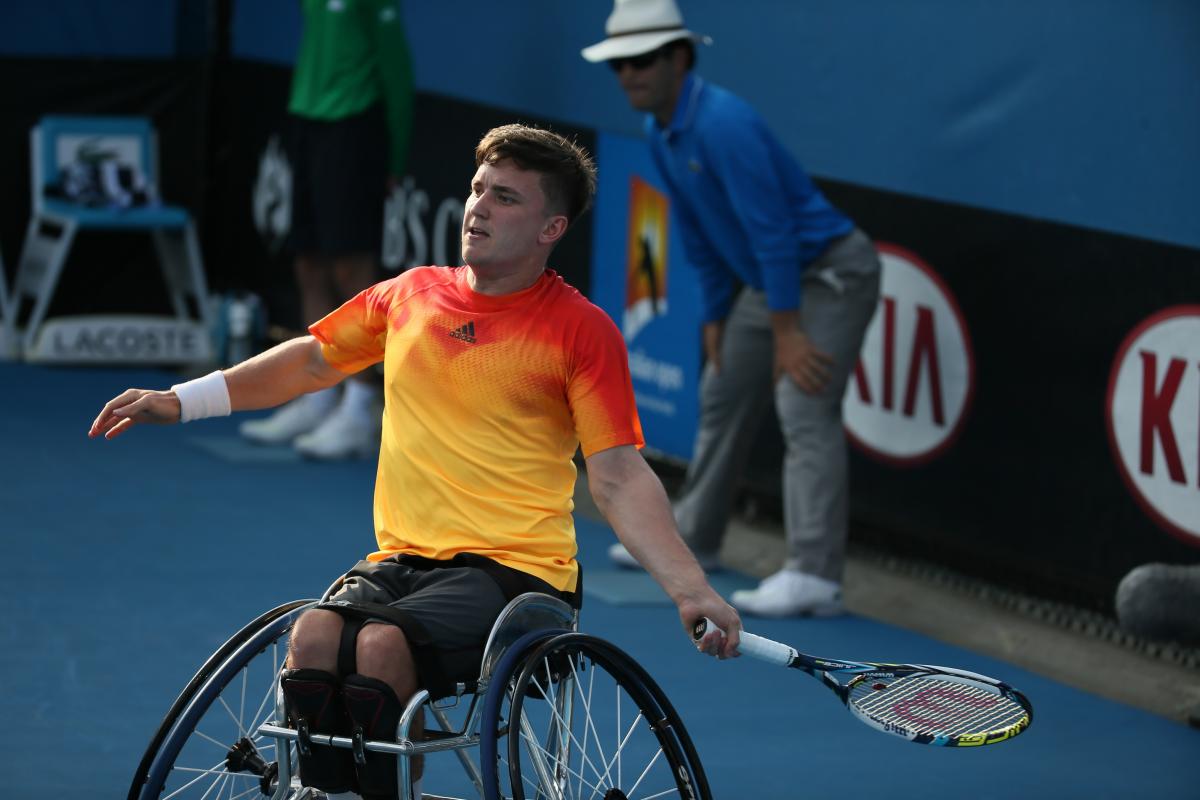 Man in wheelchair playing tennis