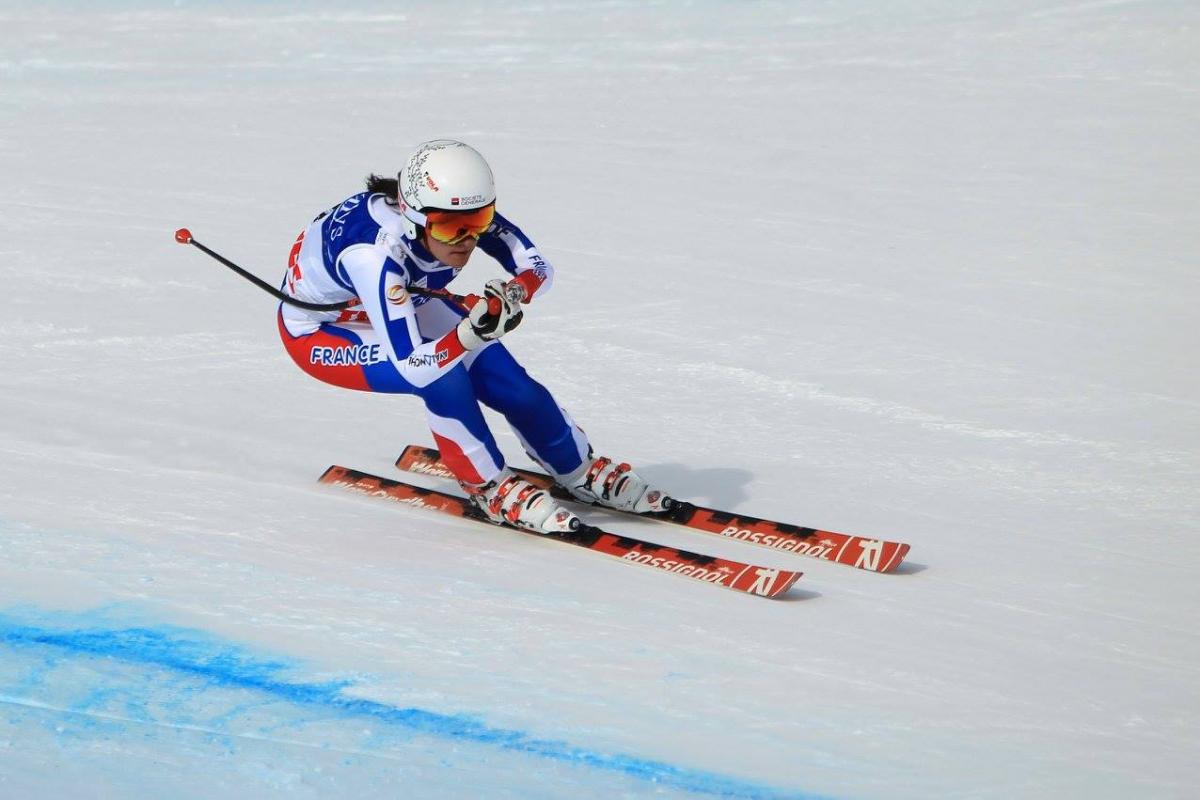 Female skier skiing downhill