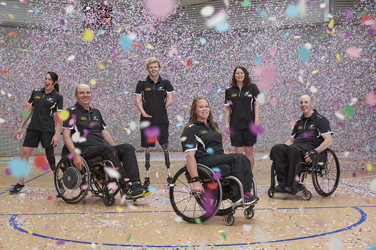 Six people standing and in wheelchairs 