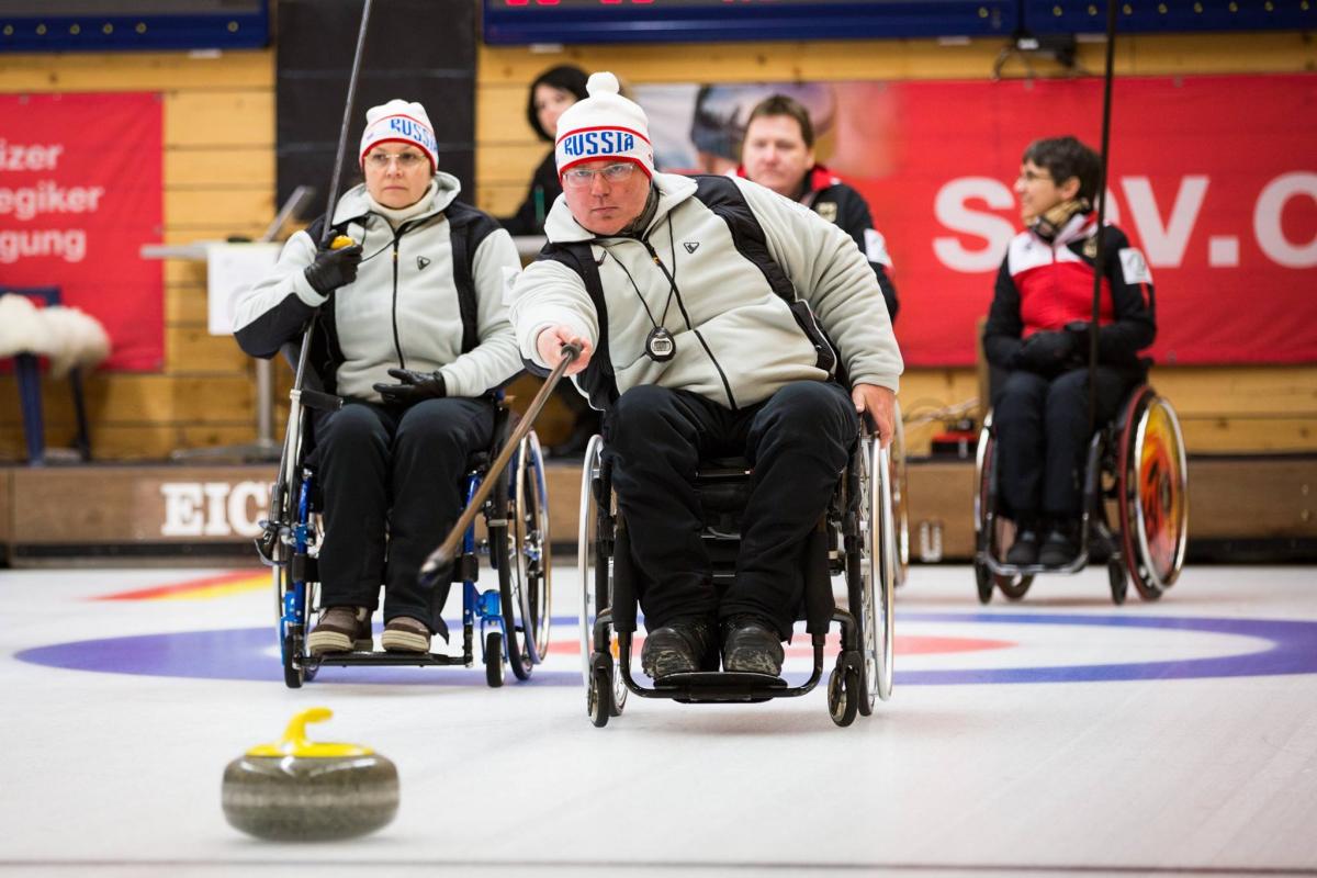 Russia - 2016 Wheelchair Curling World Championships Wheelchair curler on the ice with team in the background