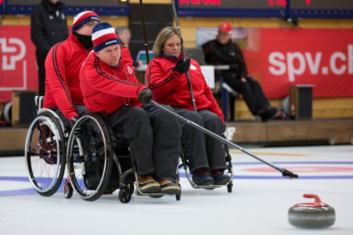 Wheelchair curlers in action