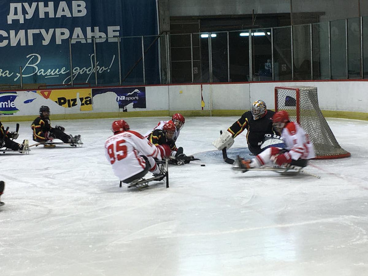 A sledge hockey field of play with players