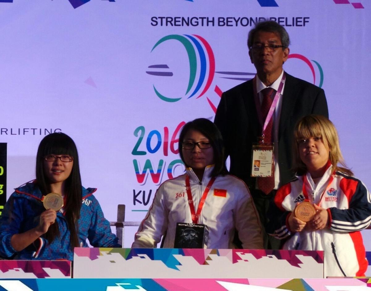 Dandan Hu, Zhe Cui, Zoe Newson - Powerlifting - Kuala Lumpur World Cup Podium of women posing for a winner picture