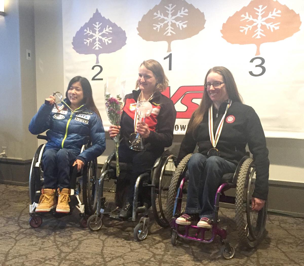 A sit-skier celebrates winning the overall super-G globe in Aspen, USA.