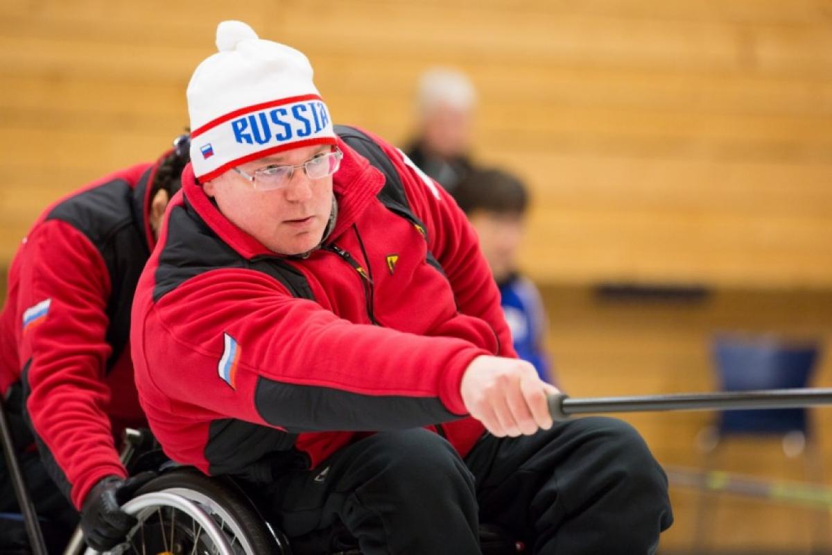 Andrey Smirnov - Russia - 2016 World Wheelchair Curling Championships Man in wheelchair doing wheelchair curling