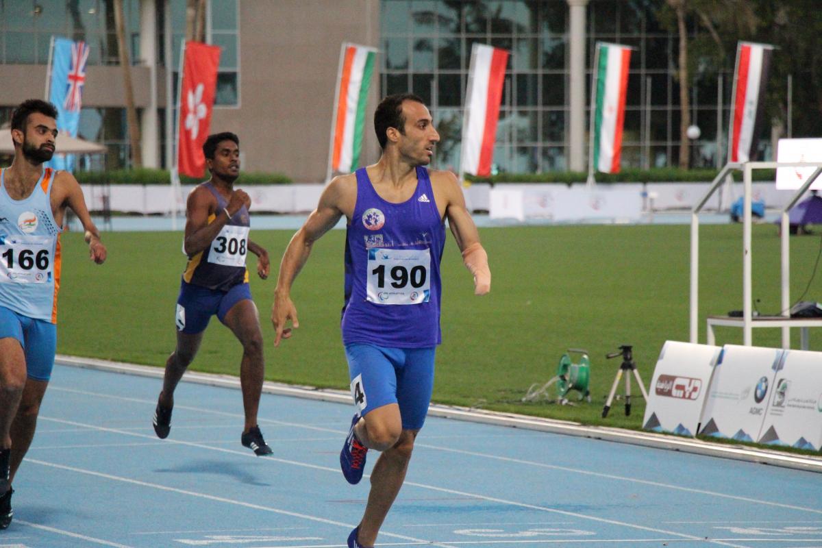 A man crossses the finish line in celebration.