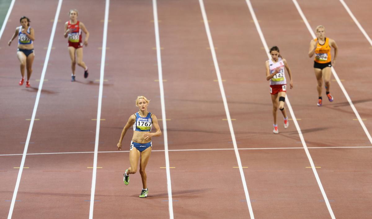 A para-athlete sprints towards the line