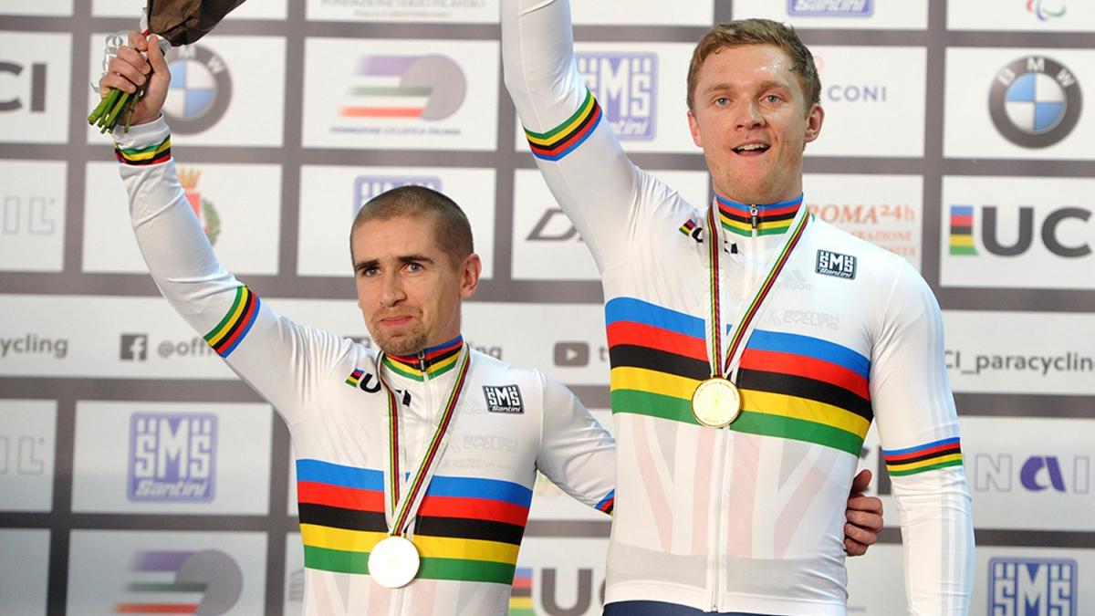 Neil Fachie, Peter Mitchell - Great Britain - Cycling Two men in white jerseys waving to the crowd