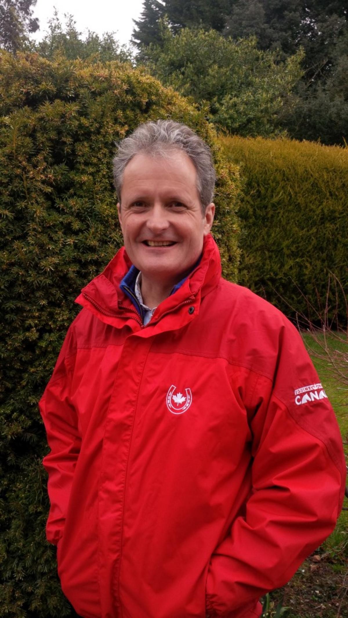 Portrait photo of a man in a red jacket