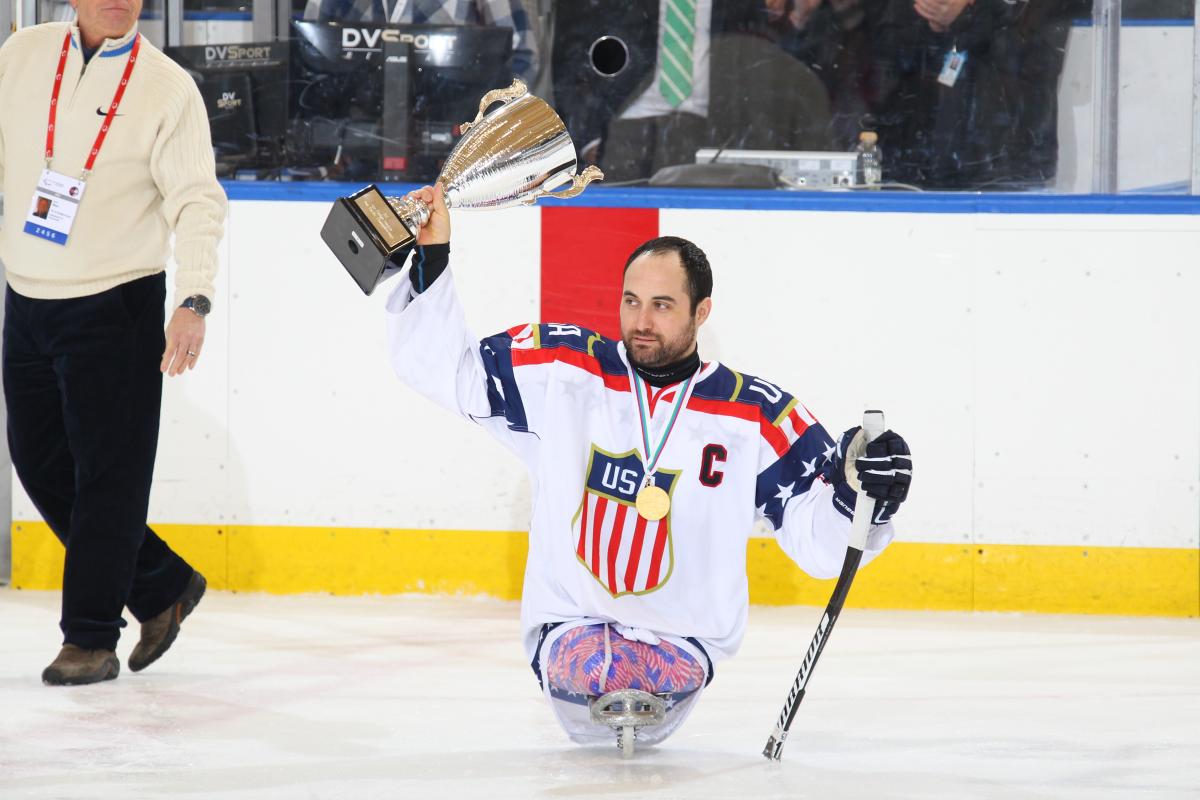 2016 Pan Pacific Sledge Hockey Man in sledge holding up a cup