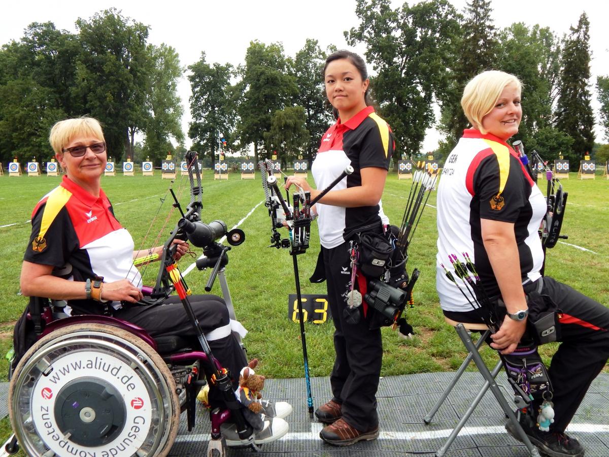 Three female archers posing