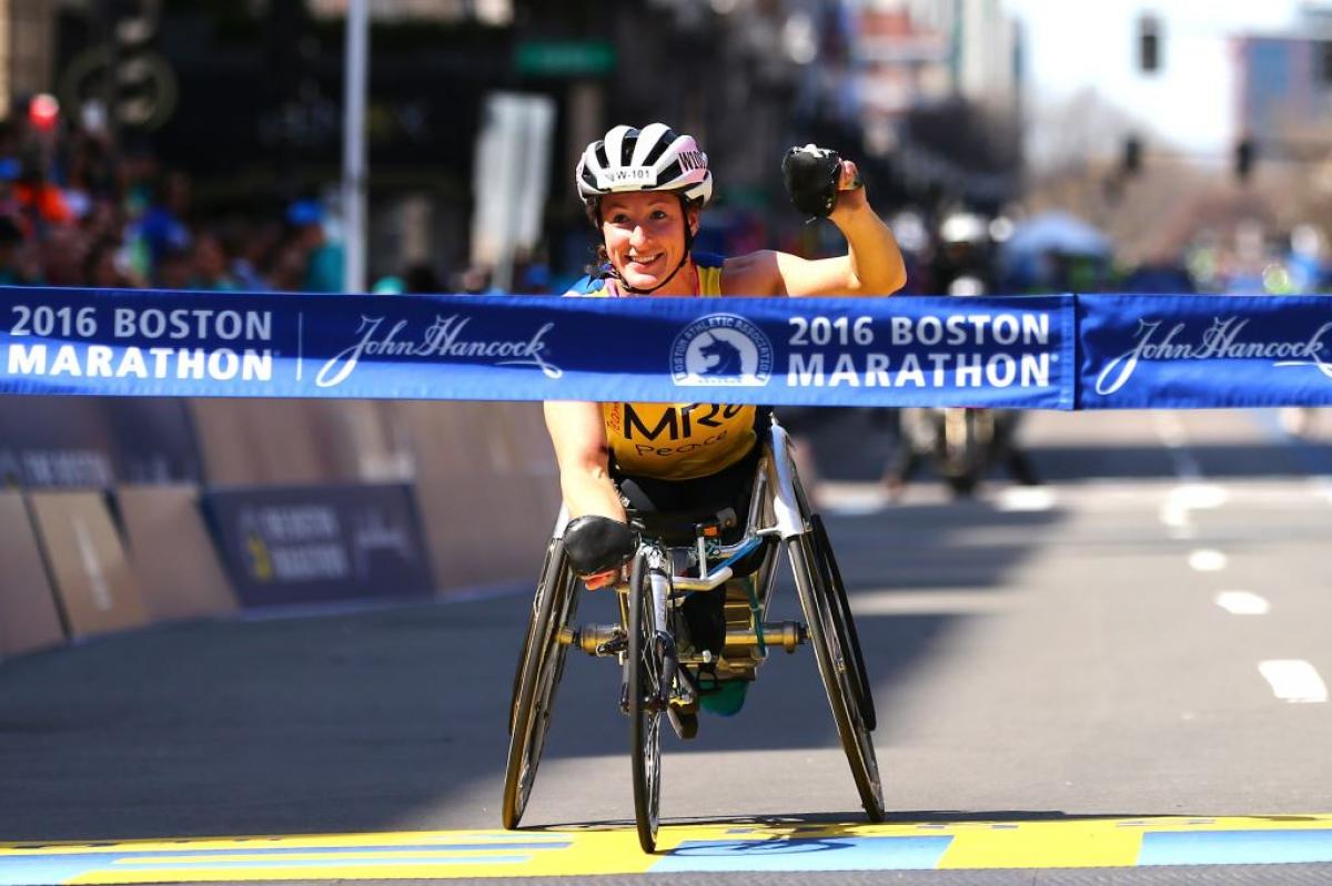 Tatyana McFadden of the United States crosses the finish line to win the women's push rim wheelchair race during the 120th Boston Marathon in Boston, Massachusetts.