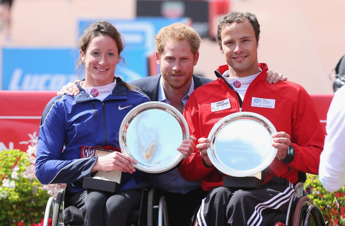 Prince Harry poses with the USA's Tatanya Mcfadden and Switzerland's Marcel Hug after both won the 2016 Virgin Money London Marathon.