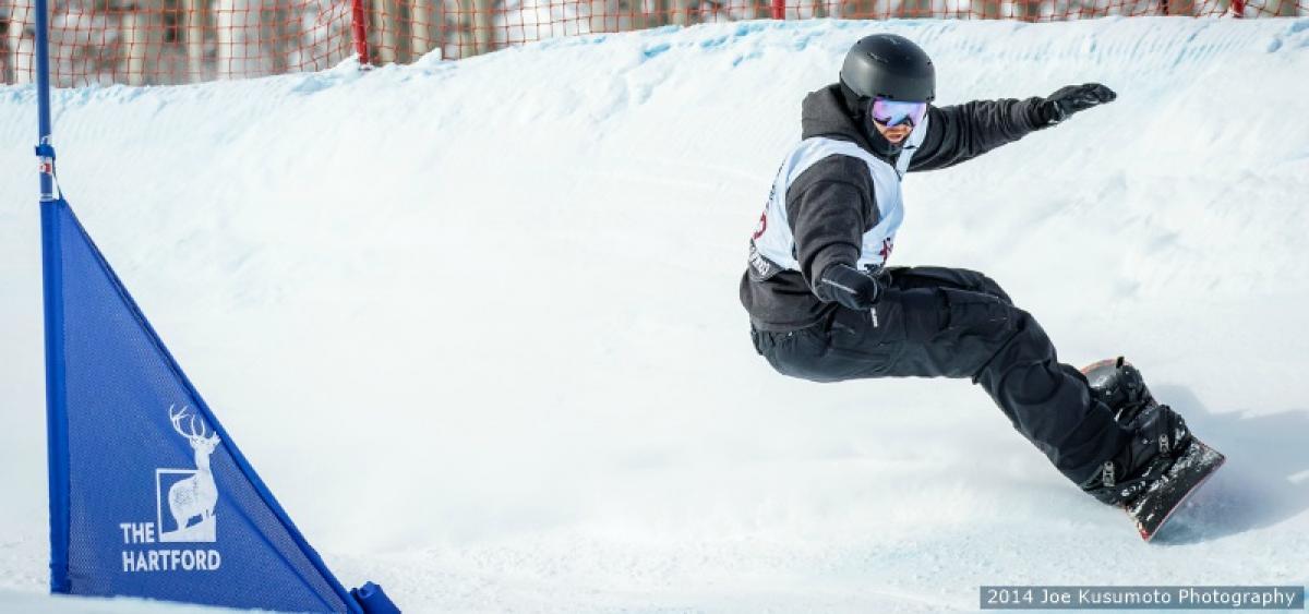 Male snowboarder going down a slope