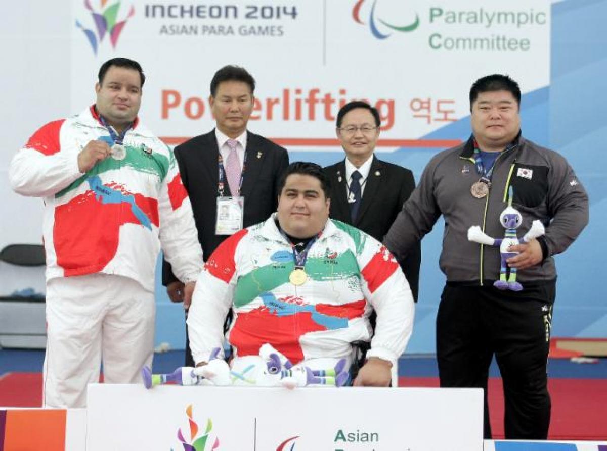 Keun Bae Chun, South Korea - Powerlifting - Asian Para Games 2014 Three athletes on a podium received their medals.