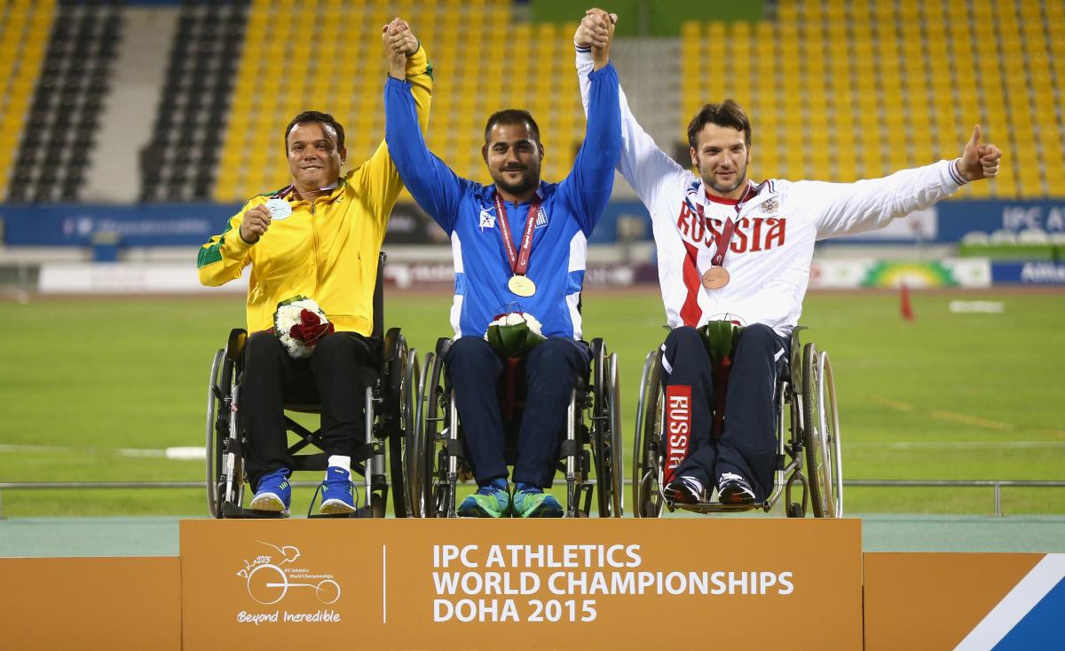 Stefanoudakis, Rodrigues, Kuznetsov - Doha 2015 Podium with three men in wheelchairs, celebrating