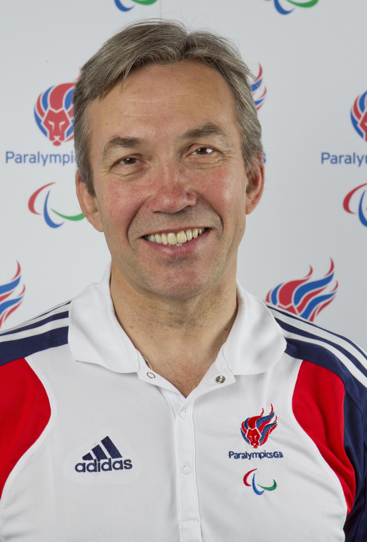 Nick Webborn wears the ParalympicsGB uniform whilst he smiles to the camera.