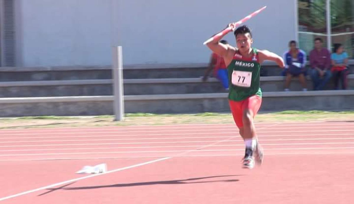 A young boy throwing a javelin