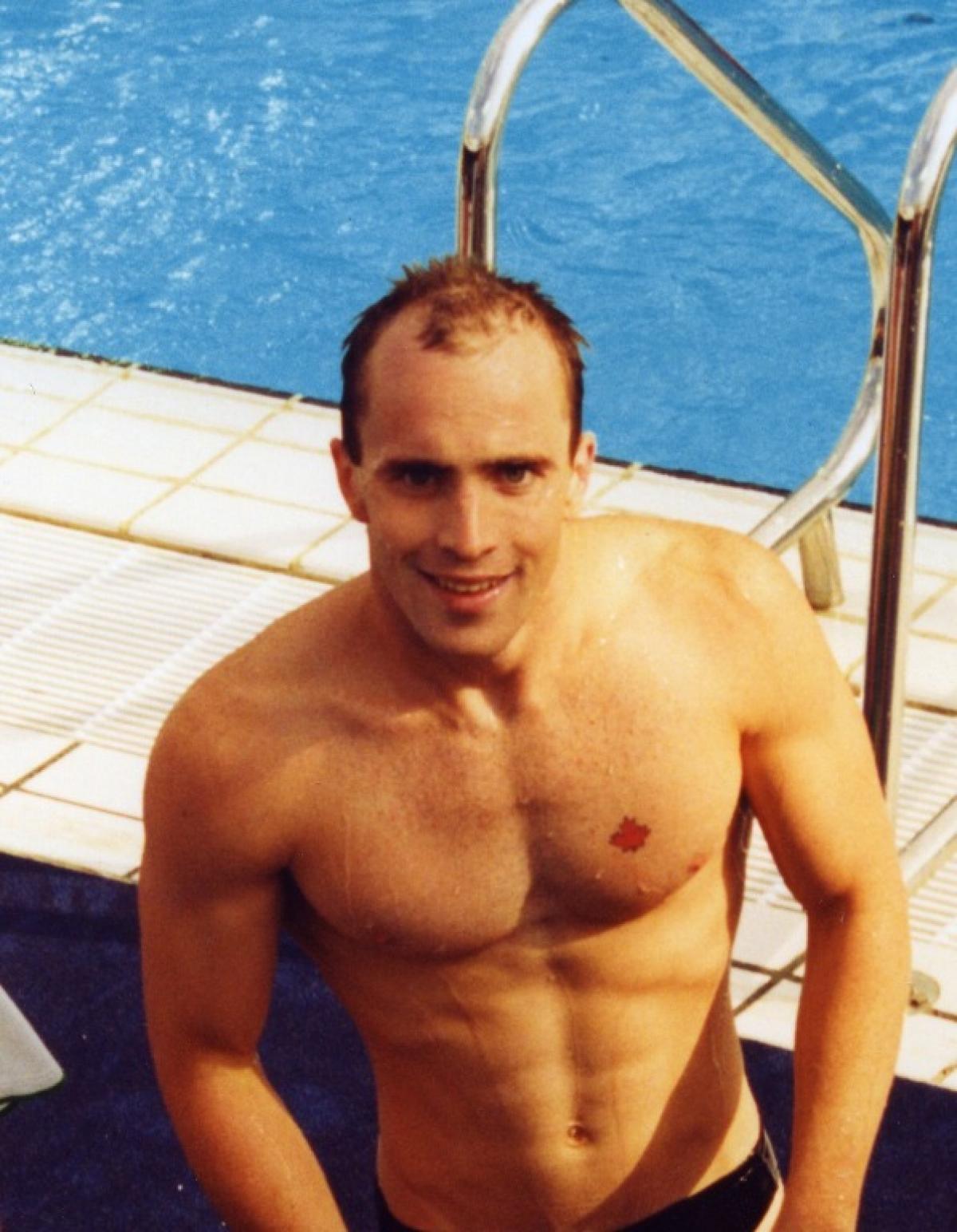Michael Edgson - Canada swimming Canadian swimmer Michael Edgson stands next to the pool after competing at Barcelona 1992.