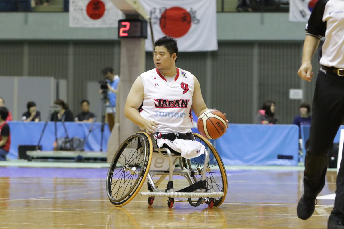 Man in wheelchair chases basketball