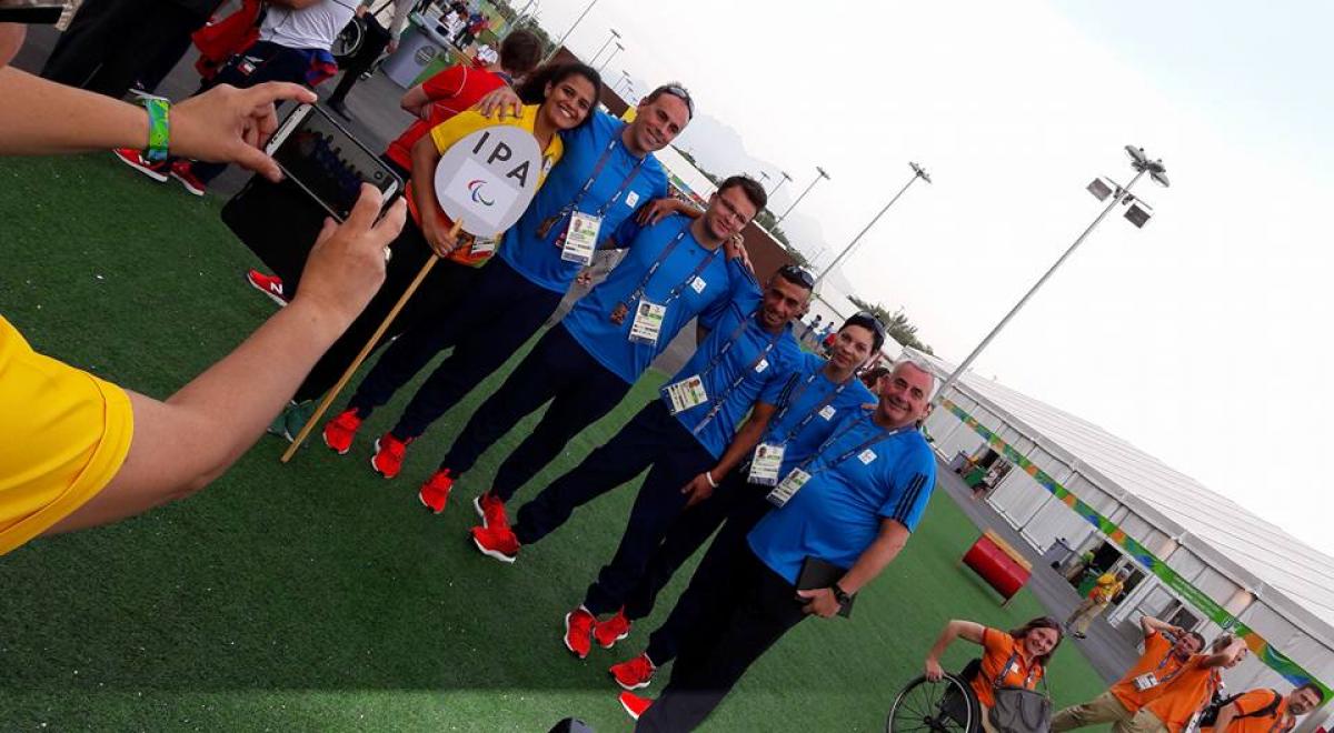 A group of people pose at the Rio 2016 Athlete Village