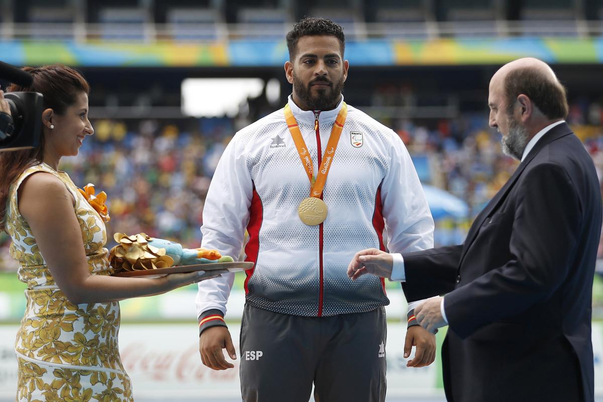 Man on podium receives medal