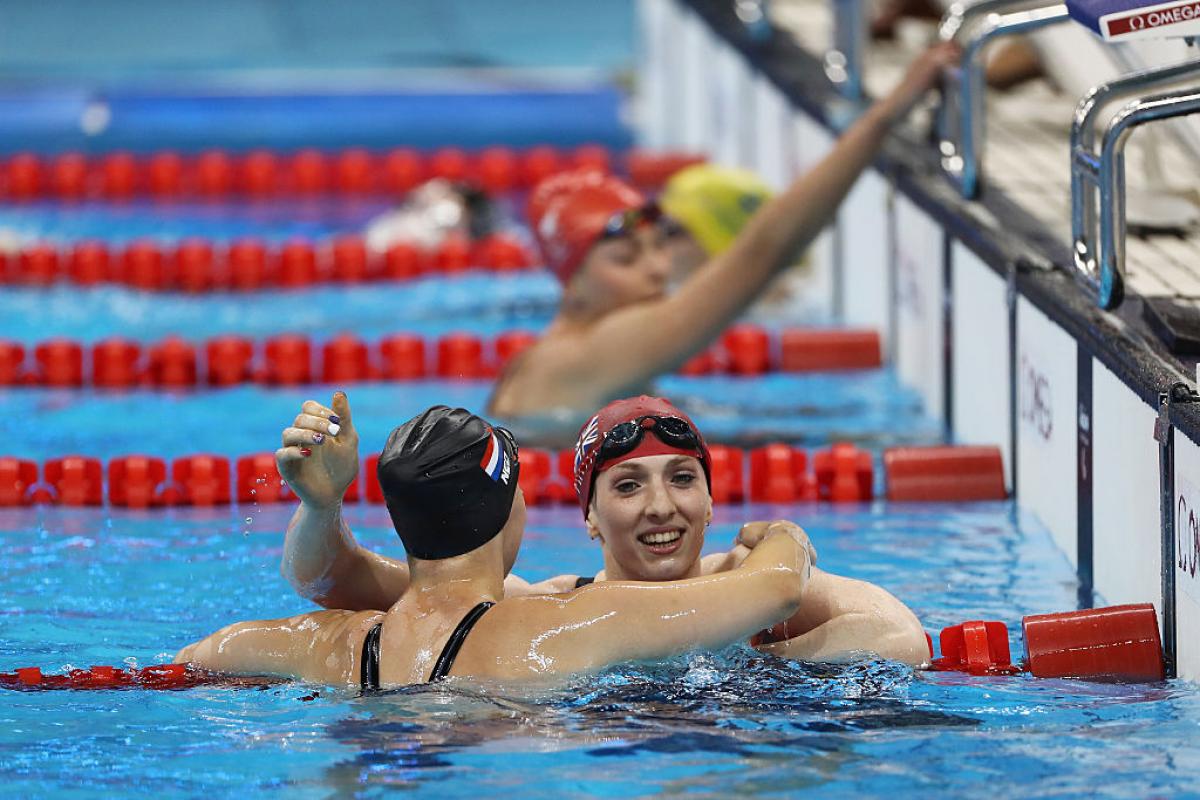 Bethany Firth (R) of Great Britain is embraced by Marlou van der Kulk (L) of the Netherlands after winning the gold medal in the Women's 100m Backstroke