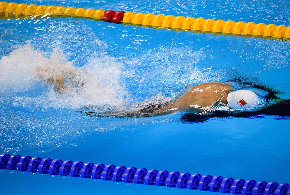 Lichao Wang CHN competes in Heat 2 of the Men's 50m Butterfly S6 at the Olympic Aquatics Stadium.