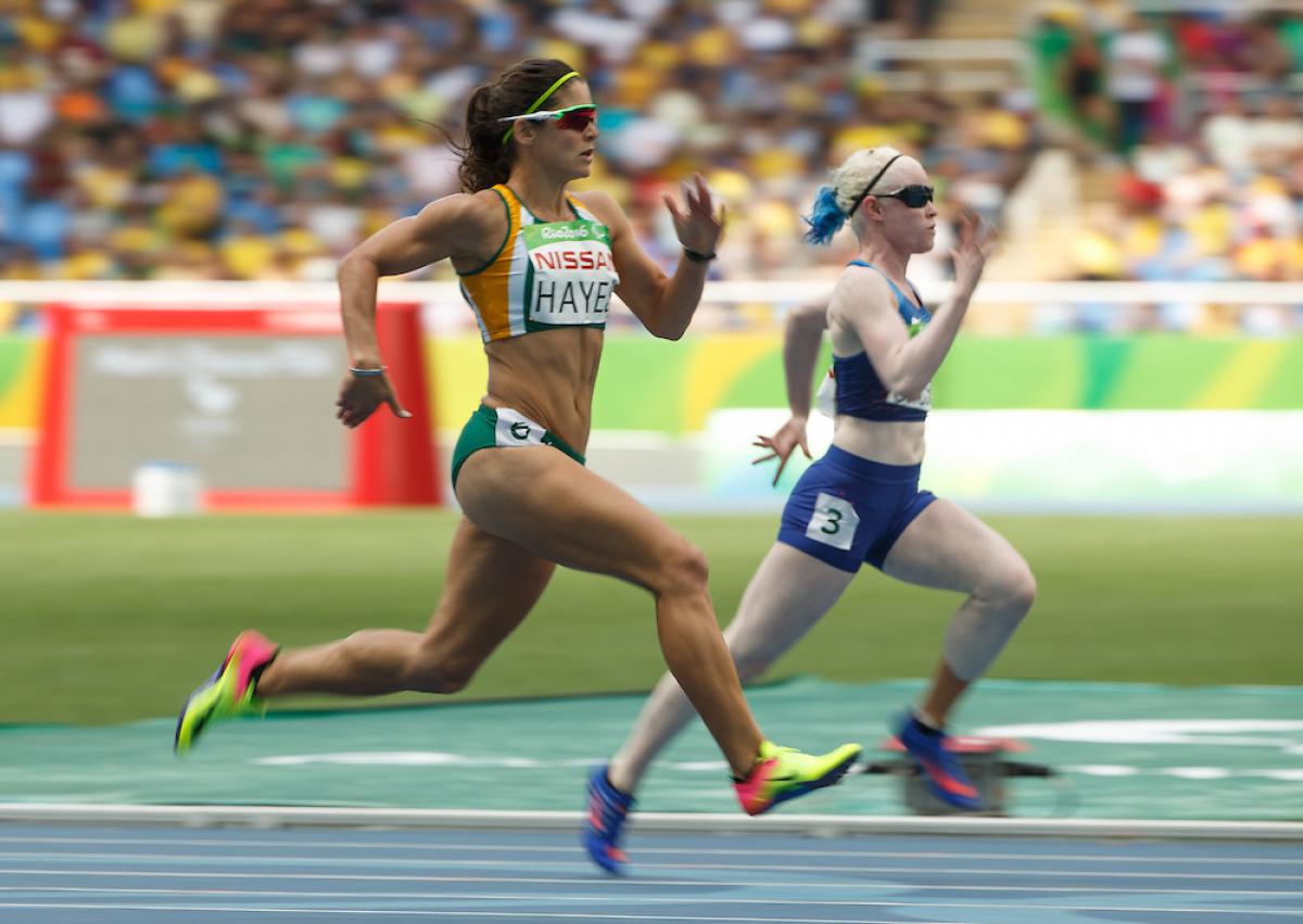 Ilse Hayes RSA and Kym Crosby USA compete in the Heat 2 of the Women's 100m - T13 at the Olympic Stadium.